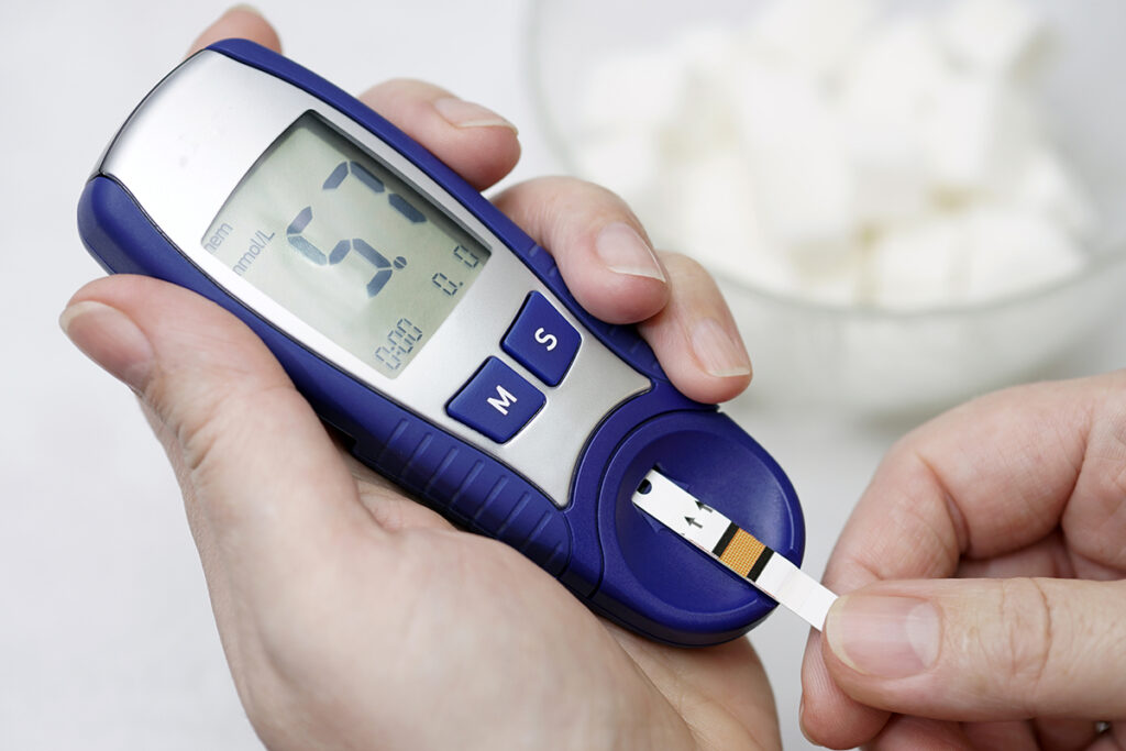 A medical test, checking a drop of blood on the sugar level.